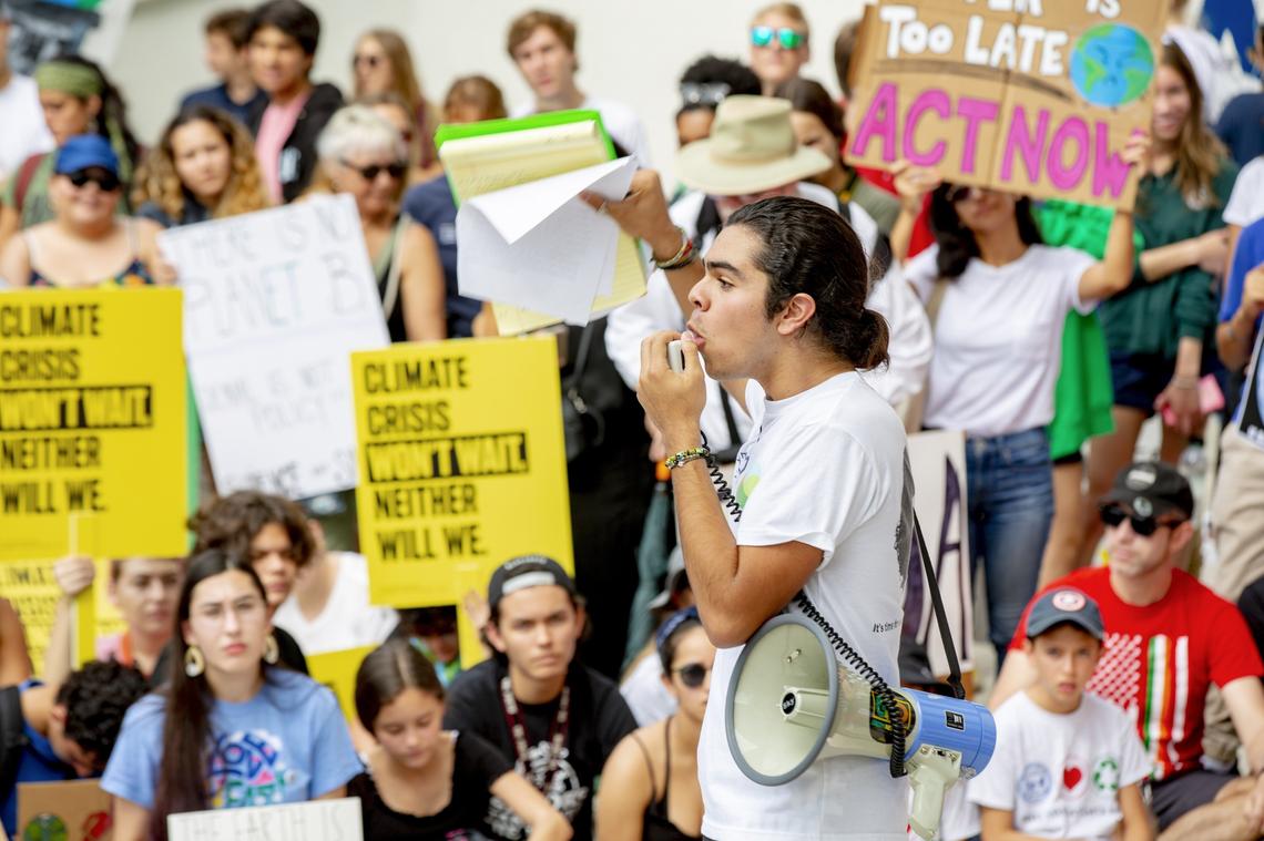Miami Beach High senior/lead student organizer John Paul Mejia, 17, addresses students from around Miami-Dade County who skipped classes to protest, in solidarity with the worldwide Global Youth Climate Strike, at City Hall in Miami Beach on Sept. 20, 2019.