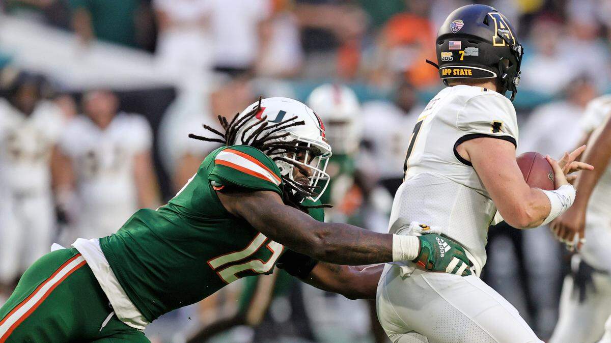 Miami Hurricanes defensive lineman Jahfari Harvey (12) is sacks Appalachian State Mountaineers quarterback Chase Brice (7) during the first quarter of their ACC football game at Hard Rock Stadium on Saturday, September 11, 2021 in Miami Gardens, Florida.