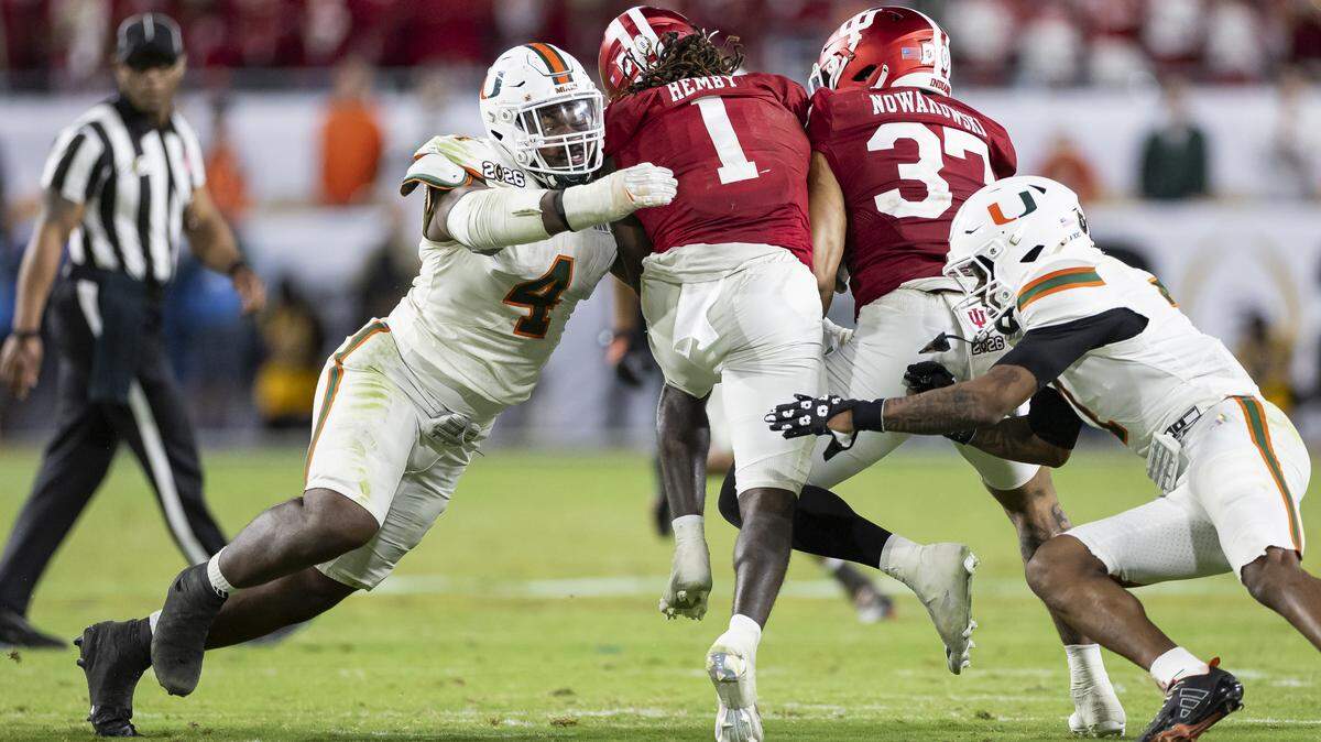 Miami Hurricanes defensive lineman Rueben Bain Jr. (4) tackles Indiana Hoosiers running back Roman Hemby (1) in the second half of their College Football Playoff National Championship Game at Hard Rock Stadium on Monday, Jan. 19, 2026, in Miami Gardens, Fla.