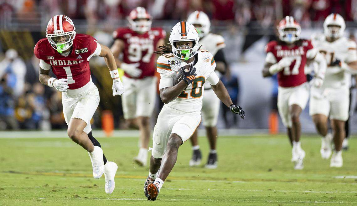 Miami Hurricanes wide receiver Malachi Toney (10) runs with the ball as Indiana Hoosiers defensive back Amare Ferrell (1) defends in the second half of their College Football Playoff National Championship Game at Hard Rock Stadium on Monday, Jan. 19, 2026, in Miami Gardens, Fla.