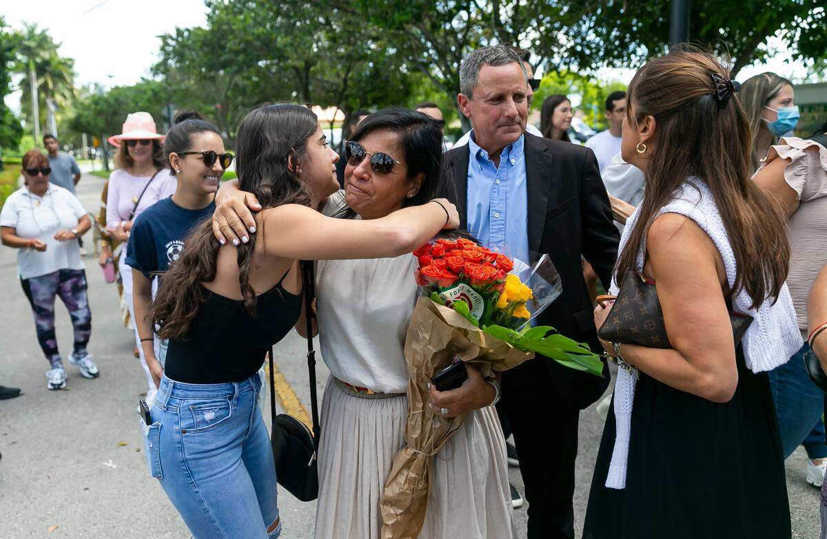 Andrea Langesfeld, center, and her husband, Pablo Langesfeld, center right, are consoled by family and friends as they arrive at a ceremony for their late daughter, Nicole, on Wednesday, June 22, 2022, in Doral, Fla.
