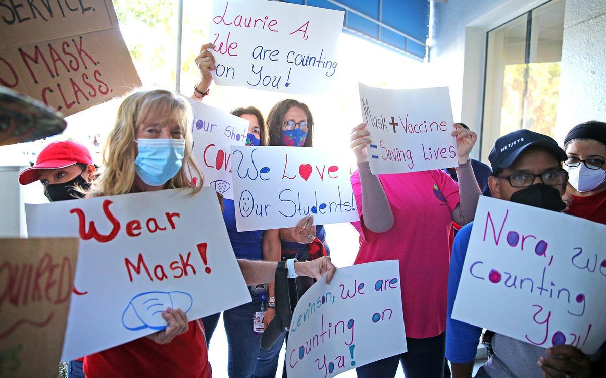 Pro-mask advocates demonstrate as the Broward County School Board holds a hearing to determine if it will impose a mask mandate for the upcoming school year.