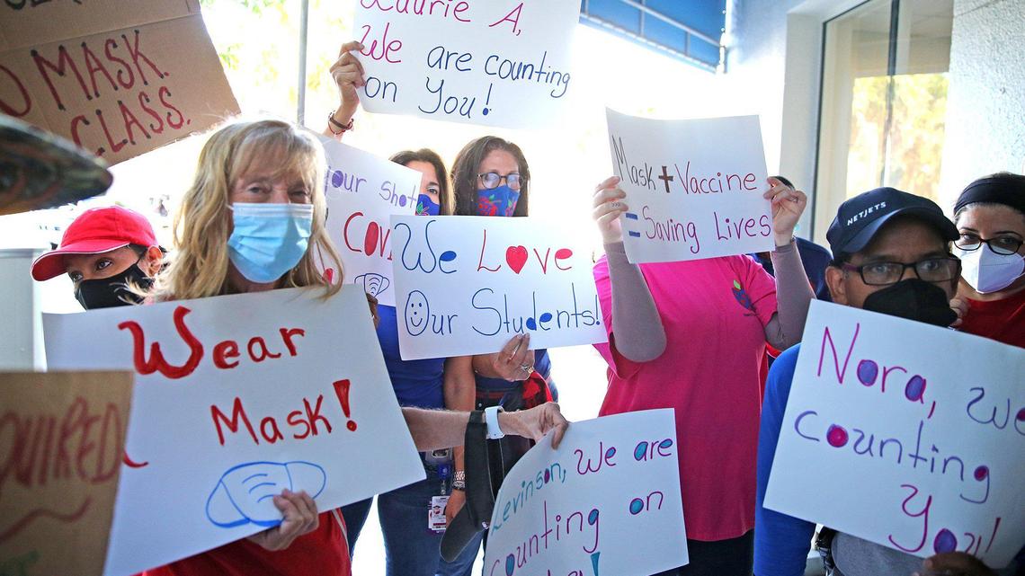 Pro-mask advocates demonstrate as the Broward County School Board holds a hearing to determine if it will impose a mask mandate for the upcoming school year.