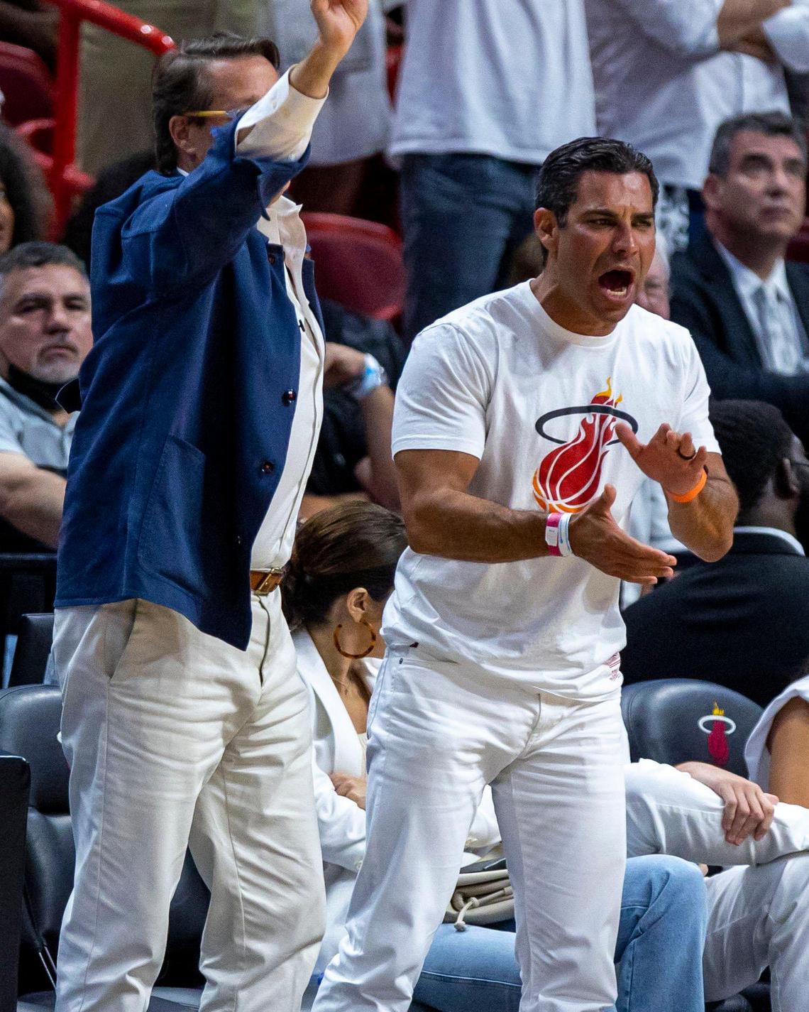 Mayor of Miami Francis X. Suarez, right, and technology entrepreneur Sean Wolfington, left, react from court-side during the first quarter of Game 1 of the NBA Eastern Conference Finals series between the Miami Heat and the Boston Celtics at FTX Arena in Miami, Florida, on Tuesday, May 17, 2022.