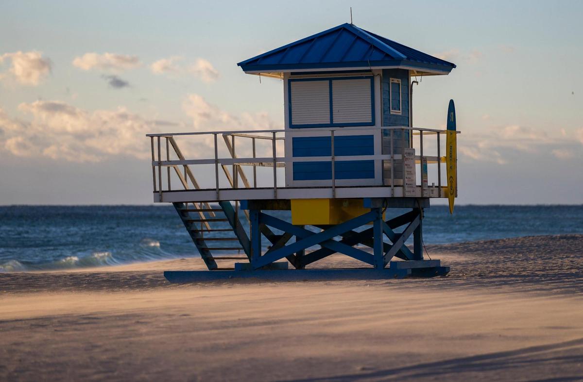 The sun rises near the Hollywood Beach Broadwalk as temperatures dip into the mid 40s on Saturday, Jan. 14, 2023, in Hollywood, Fla.