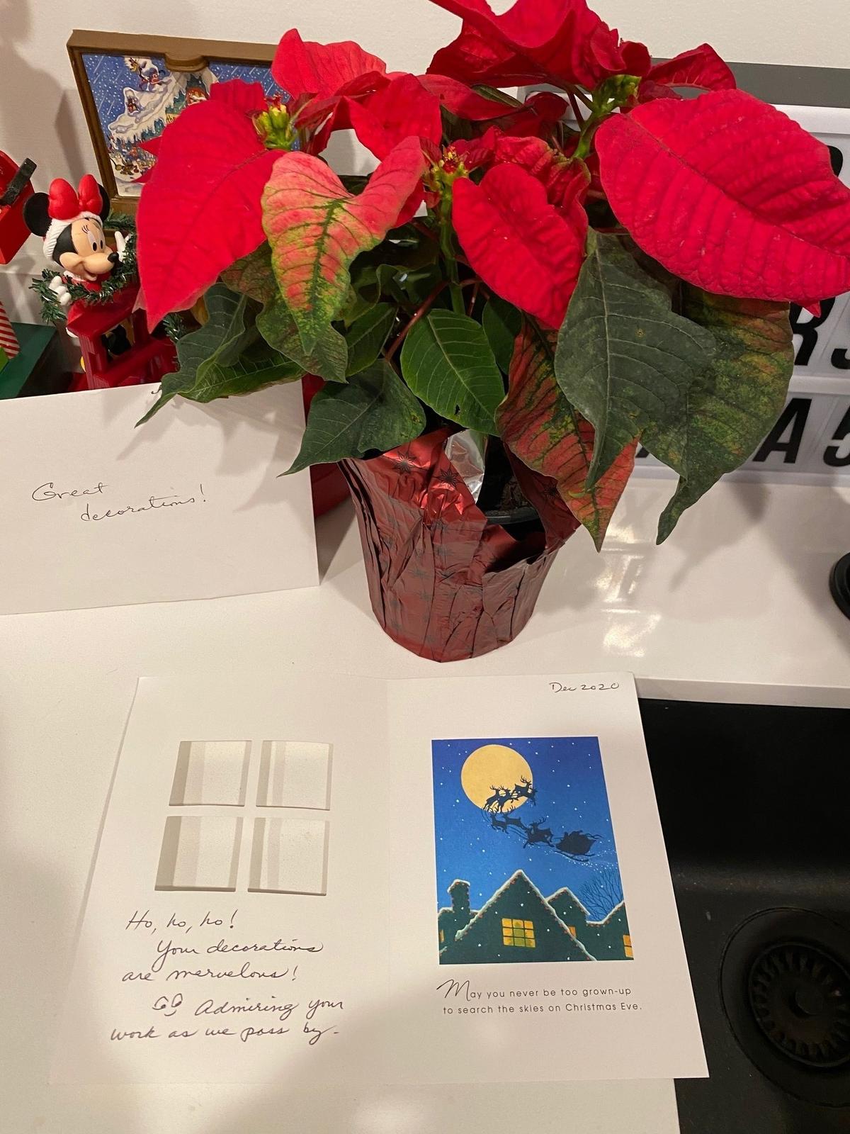 A visitor left this poinsettia and sweet note for the Pedroso family thanking them for their holiday decorations.