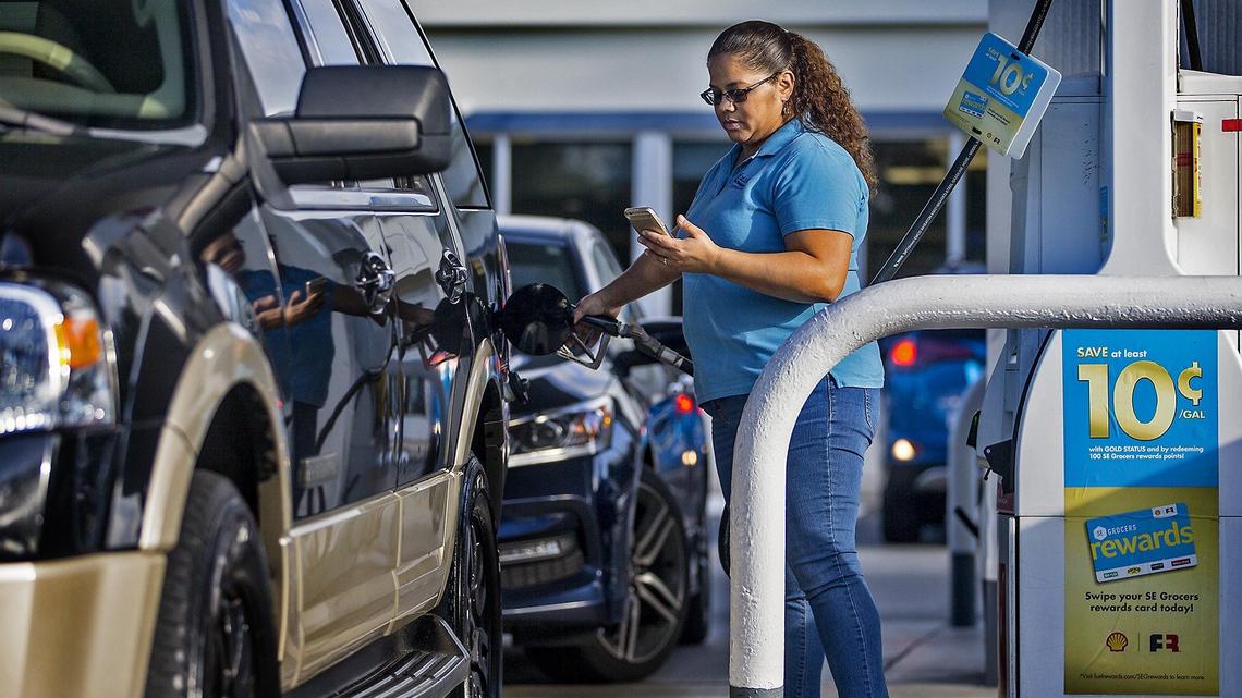 Ana Jarquin refers to her GetUpside app as she fills up with gas at a Shell gas station in Southwest Ranches on Thursday, October 18, 2018. GetUpside is one of the  apps being offered to consumers that allows them to save on gas.