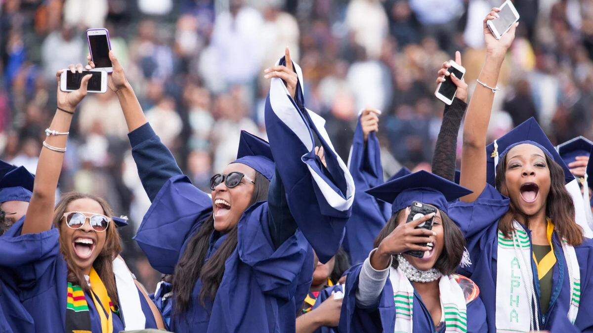 Newly minted Howard University graduates celebrate at their 2016 commencement.