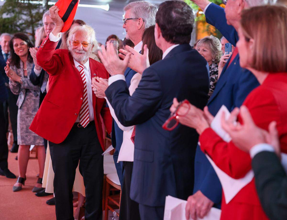 Dr. Herbert Wertheim, center, tips his hat in acknowledgment of the applause during the celebration at Baptist Health marking his historic philanthropic gift and the naming of the Herbert Wertheim Cancer Institute.Baptist Health South Florida and the Baptist Health Foundation announced the largest single philanthropic gift in the organization's 66-year history from Dr. Herbert Wertheim during a celebration of the donation and Wertheim's upcoming birthday at Baptist Health in Kendall, Wednesday, May 20, 2026, in Miami, Florida.Attendees donned red hats-a signature of Dr. Wertheim-in tribute to his visionary philanthropy and in recognition of his lasting impact on the Baptist Health and FIU. 