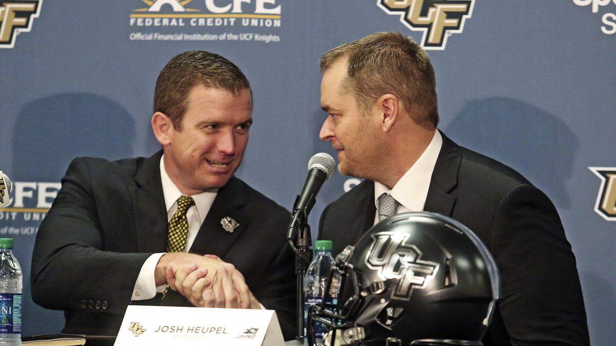 In this Dec. 5, 2017, file photo, Josh Heupel, right, is introduced as the new Central Florida head football coach by Danny White, UCF Athletic director in Orlando, Fla.