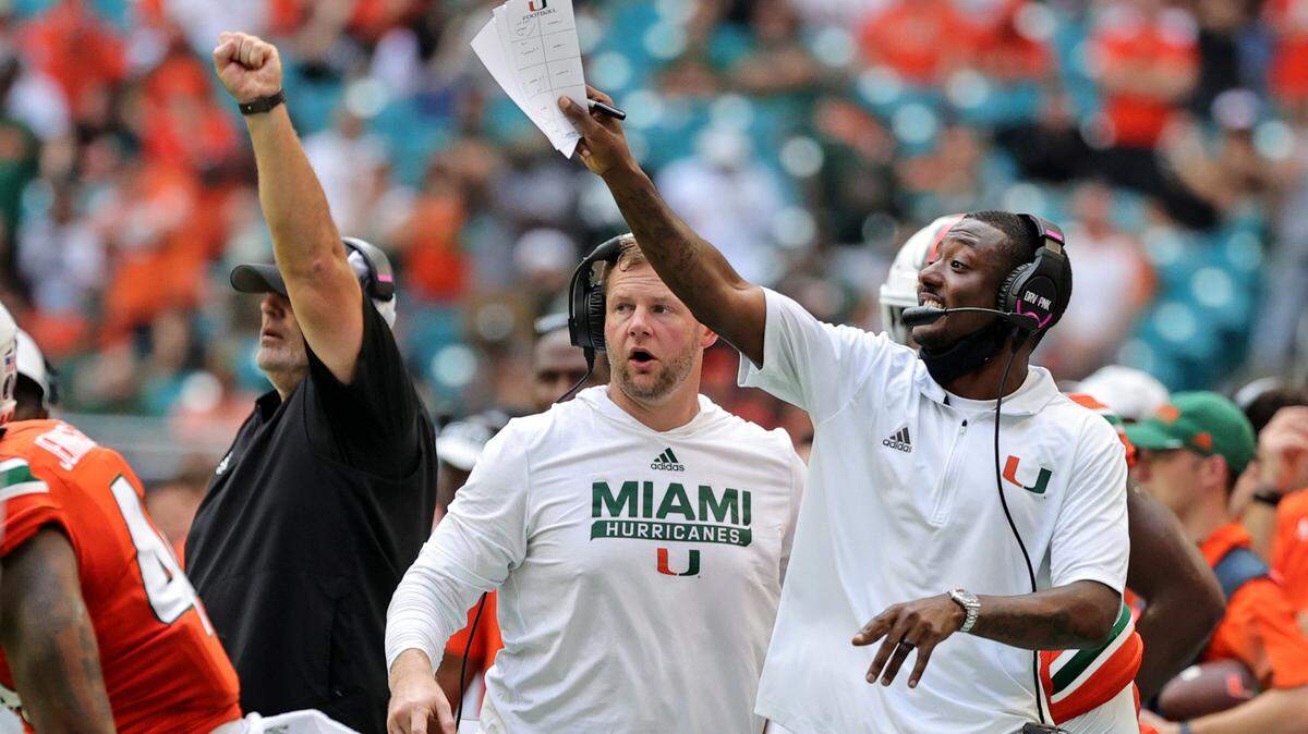 From left to right, Miami Hurricanes defensive line coach Jess Simpson, special teams coordinator Jonathan Patke and cornerbacks coach DeMarcus Van Dyke giving instructions to their players during the first quarter of their ACC football game against the Michigan State Spartans at Hard Rock Stadium on Saturday, September 18, 2021 in Miami Gardens, Florida.