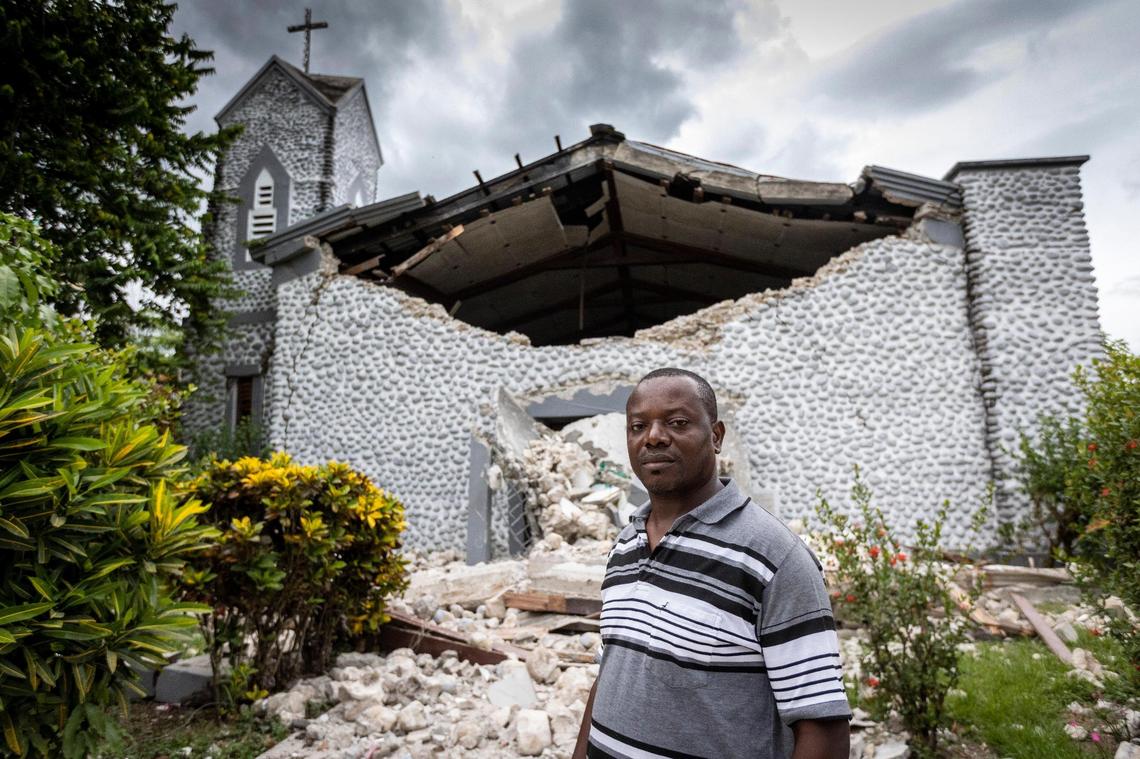 Father Corneille Fortuna stands in front of the destroyed church at Mazenod College. The high school is run by the Missionary Oblates of Mary Immaculate, a Roman Catholic order in Camp Perrin near Les Cayes. Fortuna was among those who got trapped by fallen debris during the Aug. 14, 2021, earthquake in southwestern Haiti.