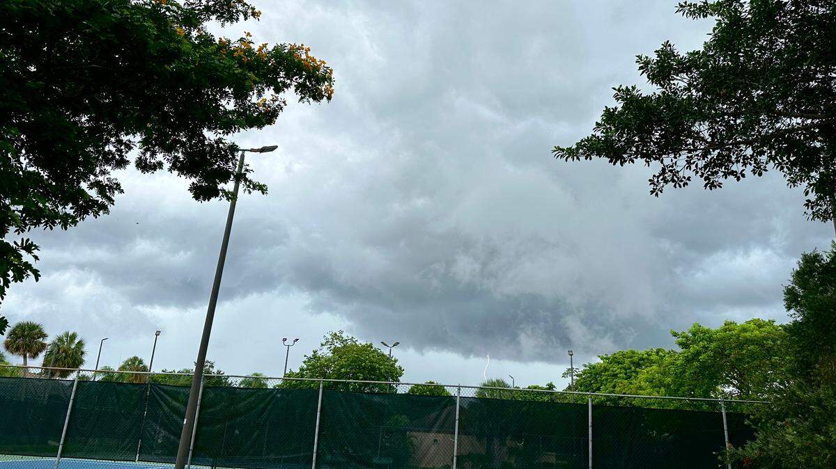 Lightning flashes from storm clouds moving in over a Kendall neighborhood around 2:30 p.m. Thursday, July 27, 2023. A tropical system in the Atlantic is sending moisture to Florida, according to National Weather Service in Miami.