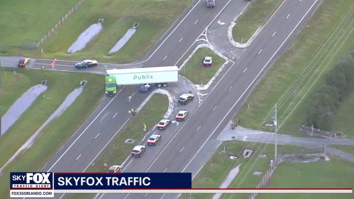 The car became lodged underneath the trailer of the semi in the crash, Florida Highway Patrol said.