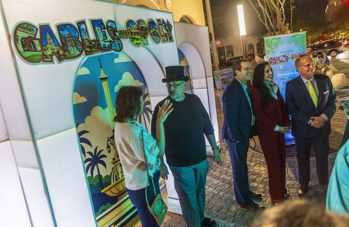 From right- Jorge L. Arrizurieta, President of the Coral gables Chamber of Commerce Cristina Miller, President of the Coral Gables Foundation and Jorge Martinez, joined   Eddy Martinez (with hat), owner of the BLISS Imprints & Gifts store, during the launching of the new Coral Gables-themed Monopoly-style game to players during the launching event celebrated at the Giralda Plaza in Coral Gables. The Gables-opoly is part of a fundraising initiative by the Coral Gables Chamber of Commerce, on Friday, March 06, 2026.
