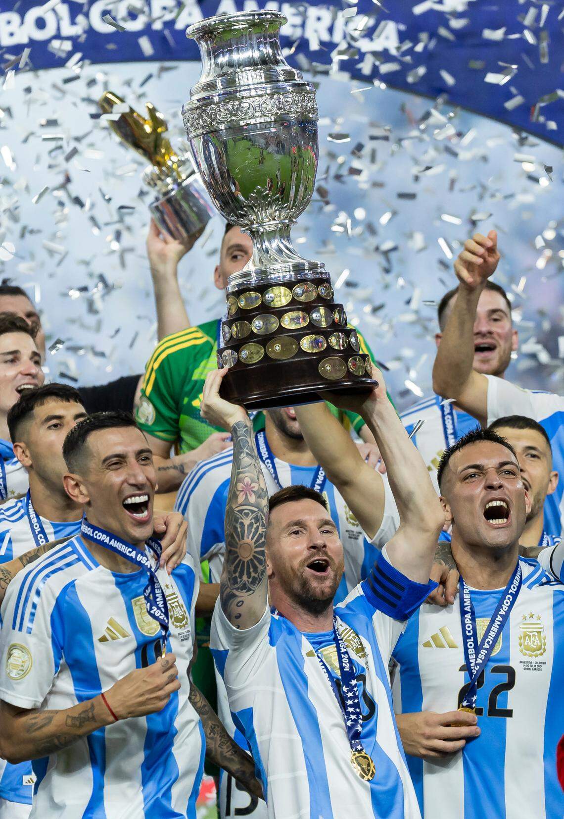 Argentina forward Lionel Messi (10) holds the trophy with his teammates after defeating Colombia in their Copa America 2024 Final soccer match at Hard Rock Stadium on Sunday, July 14, 2024, in Miami Gardens, Fla.