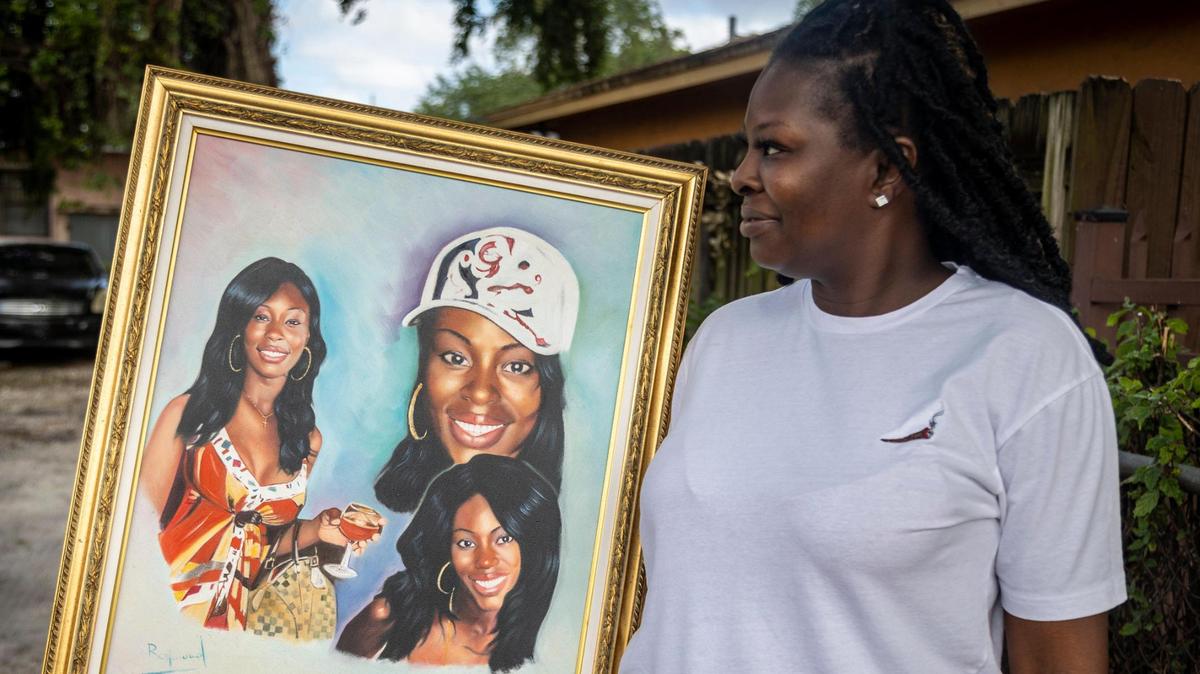 Lashon Jones holds a composite of pictures of her murdered sister, Vickie Simmons, in Miami on April 5, 2022. The suspect in the 2009 murder is the same man who police say shot and killed his wife at the Jewish Community Center last Sunday.