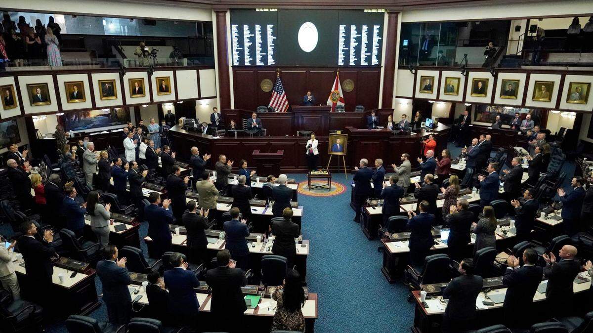 Members of the Florida House of Representatives give Speaker of the House Chris Sprowls a standing ovation after Sprowls gave his farewell speech and had his official portrait unveiled during a legislative session at the Florida State Capitol, Thursday, March 10, 2022, in Tallahassee, Fla.
