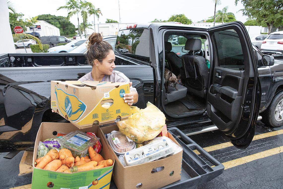 Sofia Becker puts boxes of food into her car that she received from Bridge to Hope on Thursday, September 18, 2025 in Cutler Bay. Andrew Uloza / for Miami Herald