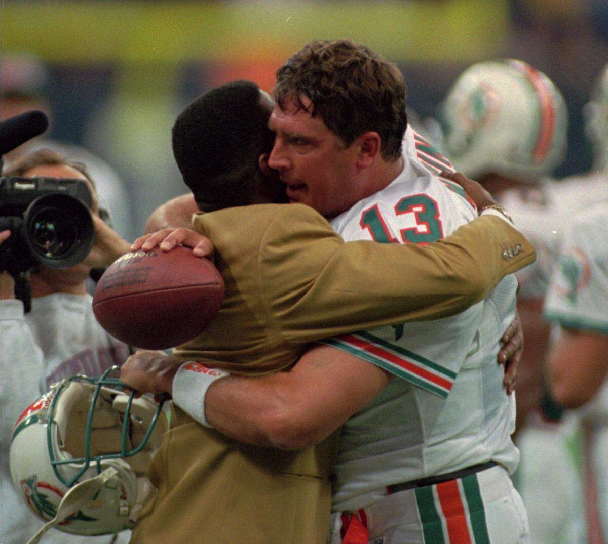 Miami Dolphins quarterback Dan Marino, right, is congratulated by former wide receiver Mark Clayton after Marino broke the all-time record for touchdown passes in the second quarter in Indianapolis Sunday, Nov. 26, 1995.