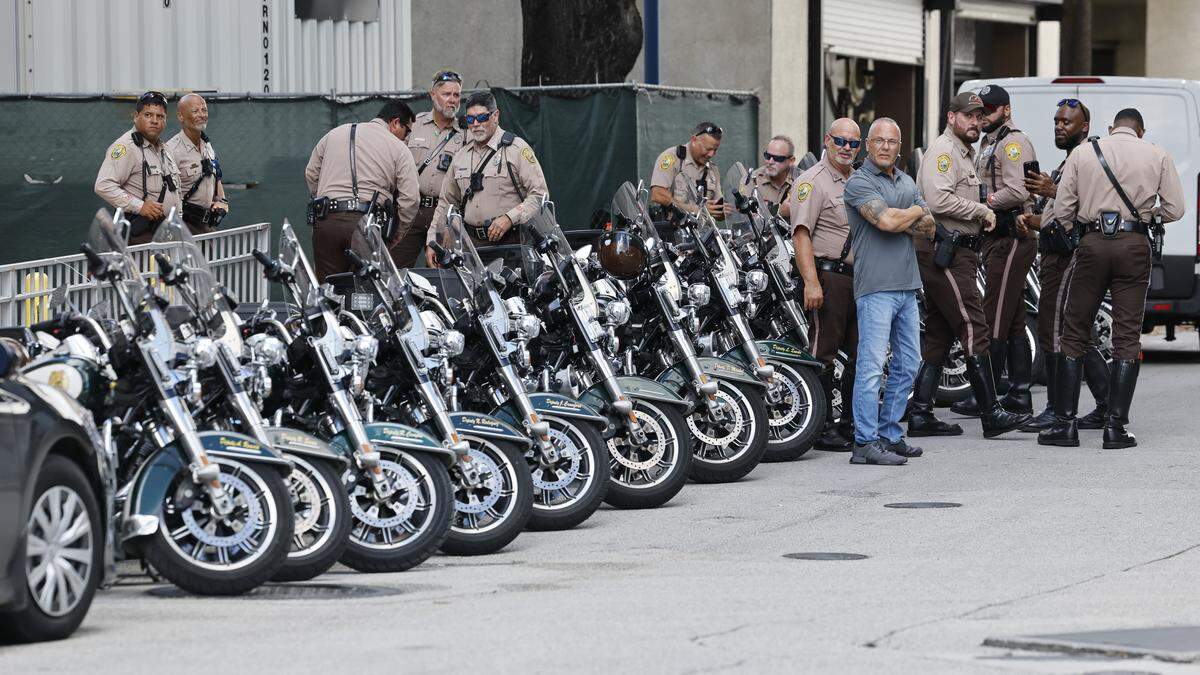Police officers stand outside Ryder Trauma Center at Jackson Memorial Hospital after two Miami police officers were shot while responding to a call of a shooting on Thursday morning in Allapattah, Oct. 9, 2025. The injured officers were taken to the trauma center and are in stable condition. 