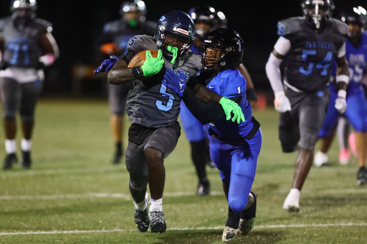 Palmetto Panthers running back Varian Terry (5) runs with the football against South Dade Buccaneers cornerback Willie White (1) during the second quarter of a high school football game at Harris Field in Homestead, Florida, Friday, October 4, 2024.