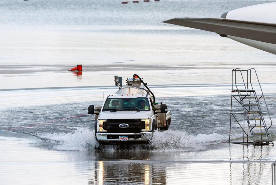 A truck drives through the flooded tarmac at the Fort Lauderdale-Hollywood International Airport on Thursday, April 13, 2023.