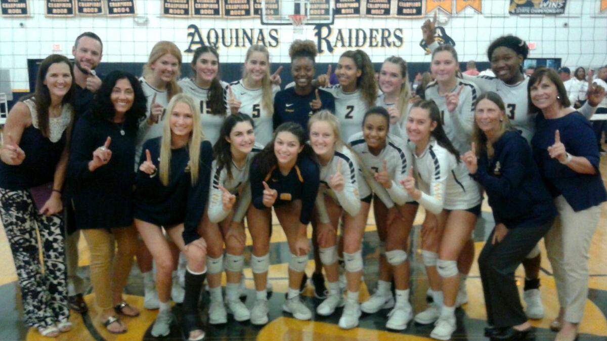 The St. Thomas Aquinas girls volleyball team poses after winning their Class 6A state semifinal contest on Saturday, Nov. 9, 2019.