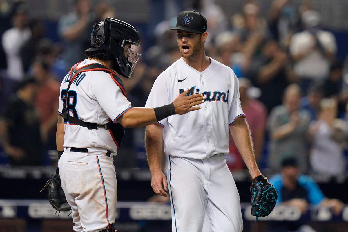 Miami Marlins catcher Jorge Alfaro, left, and relief pitcher Anthony Bender celebrate after they defeated the Los Angeles Dodgers in a baseball game, Monday, July 5, 2021, in Miami.