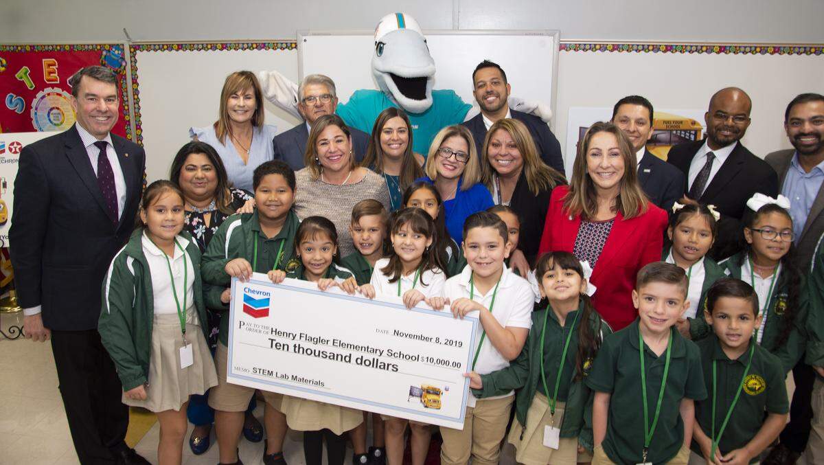 Representatives from Chevron’s Fuel Your School Program made a surprise visit to Henry Flagler Elementary School to donate supplies and $10,000 to fund four classroom projects and help complete the school’s new robotics lab. Pictured above with students, from left to right, are Damon Echevarria, vice president, Americas Products U.S. East & Latin America, Chevron; Diana Venturini, executive director at Miami-Dade County Public Schools, Office of Community Engagement; Max Alvarez, founder and president of Sunshine Gasoline Distributors; Principal Zulema Lamazares; Susie Castillo, school board member, District 5; John Pace, central region superintendent, Miami-Dade County Public Schools; and Shashank Nanavati, district sales manager, Chevron.