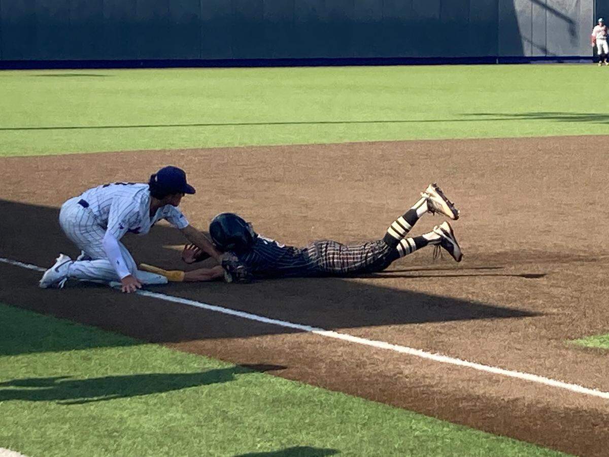 Columbus third baseman Brady Kehan puts the tag on Western’s Aiden Andrew who was out at third on a throw from center trying to tag up from second, which ended the first inning of Tuesday’s Region 4-7A quarterfinal at Columbus.