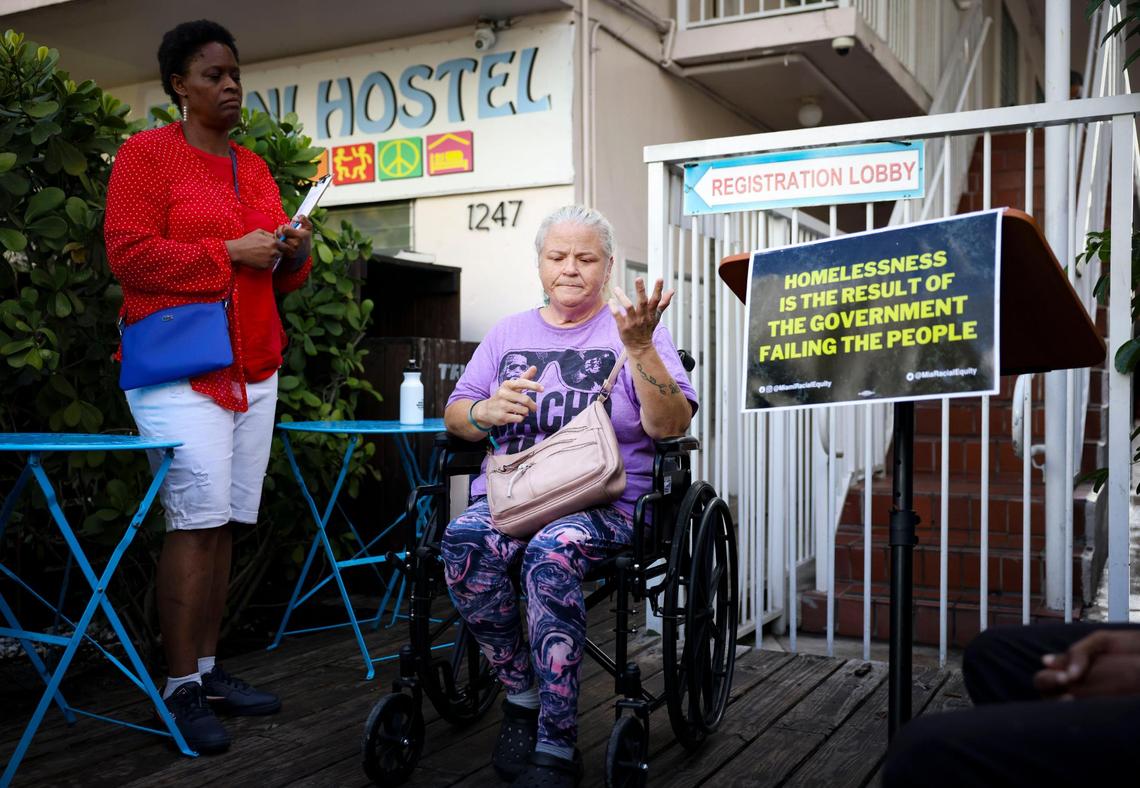 Angela Lovingood, center, gets emotional while speaking about how she became homeless after losing her daughter to a fire during a press conference on Wednesday, March 5, 2025, outside of the Bikini Hostel in Miami Beach, Florida.