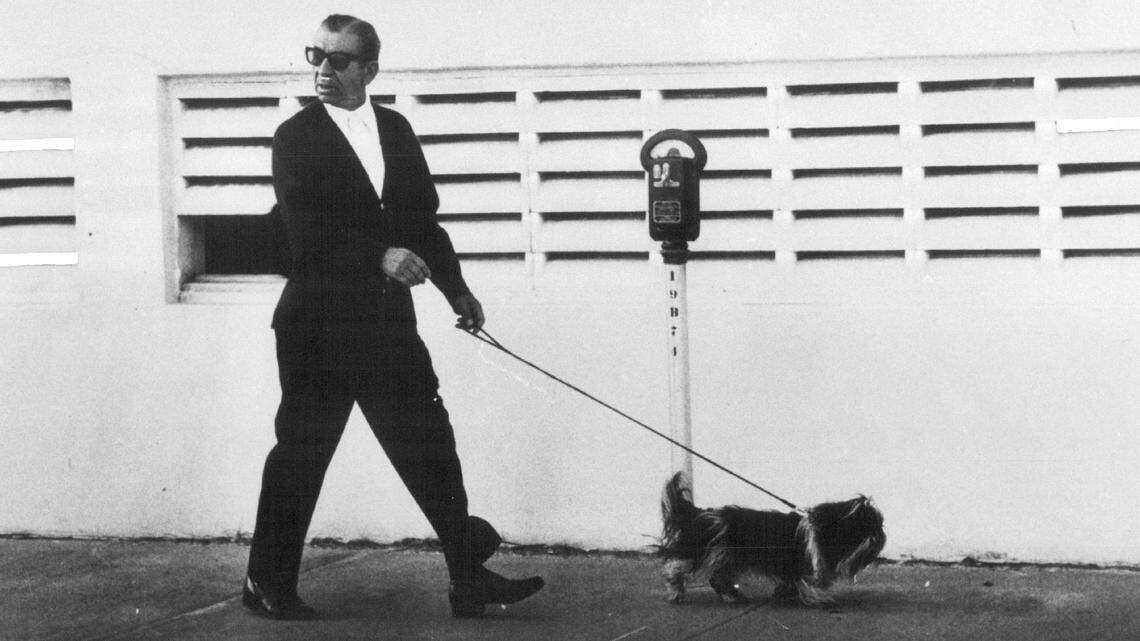 Meyer Lansky walks his dog.