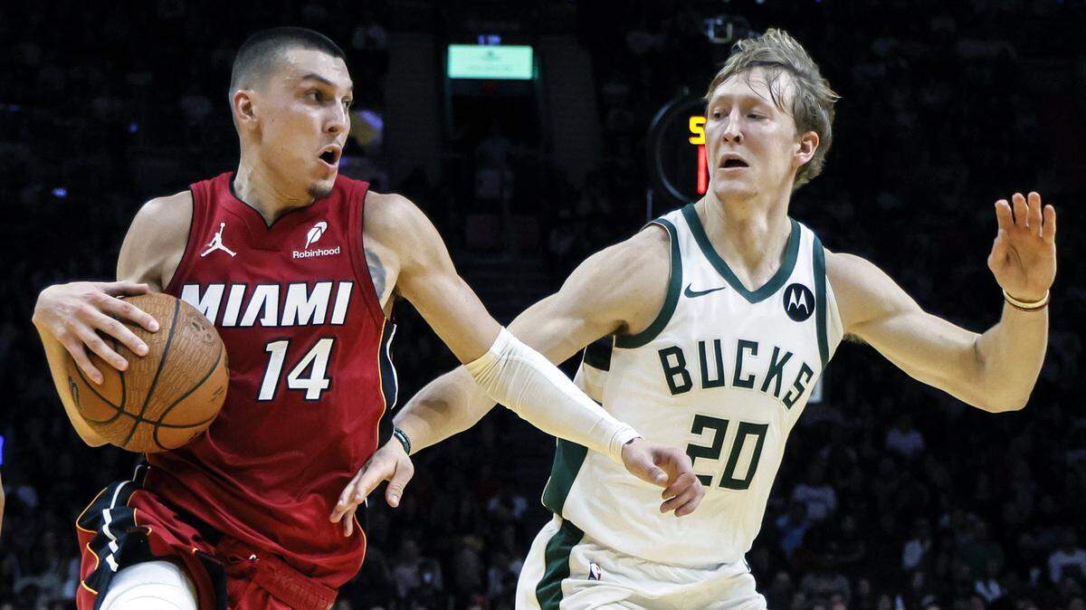 Miami Heat guard Tyler Herro (14) drives the ball as Milwaukee Bucks guard AJ Green (20) defends in the second half of their NBA basketball game at Kaseya Center in Miami on November 26, 2025.