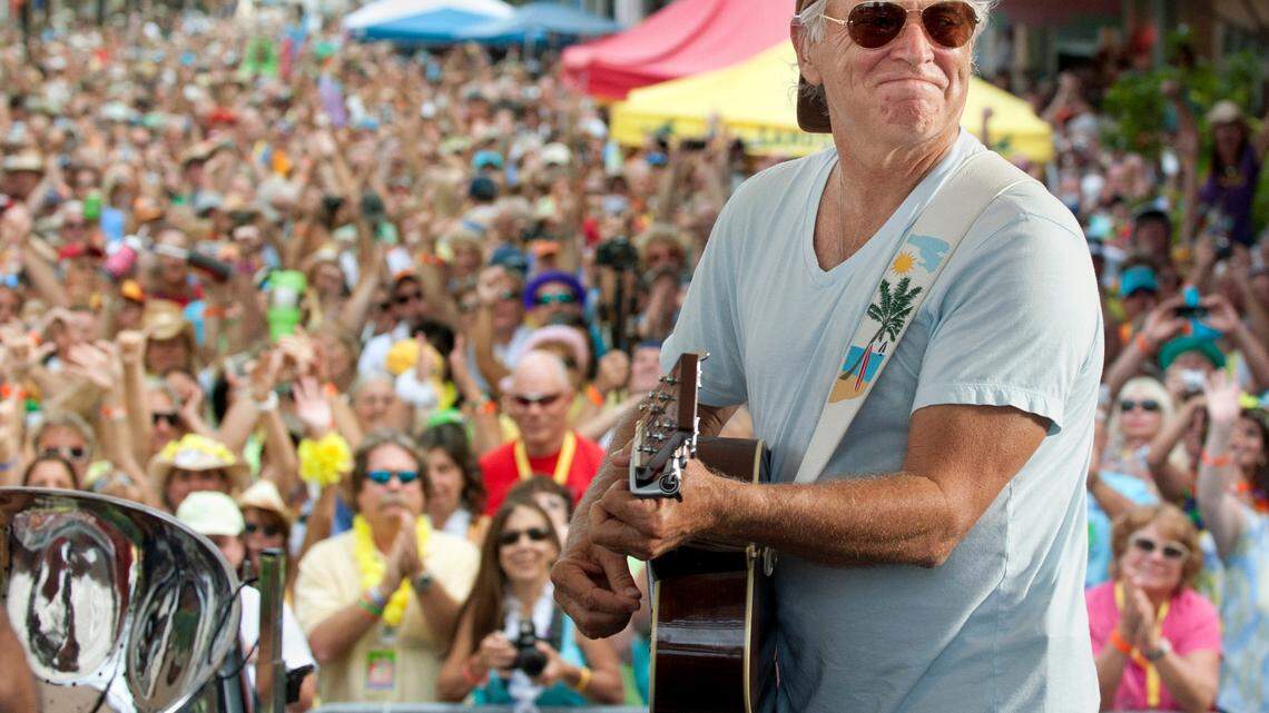 In this Nov. 4, 2011, file photo released by the Florida Keys News Bureau, singer/songwriter Jimmy Buffett performs before fans on Duval Street in Key West. Buffett, who popularized beach bum soft rock with the escapist Caribbean-flavored song “Margaritaville” and turned that celebration into an empire of restaurants, resorts and frozen concoctions, died Friday, Sept. 1, 2023.