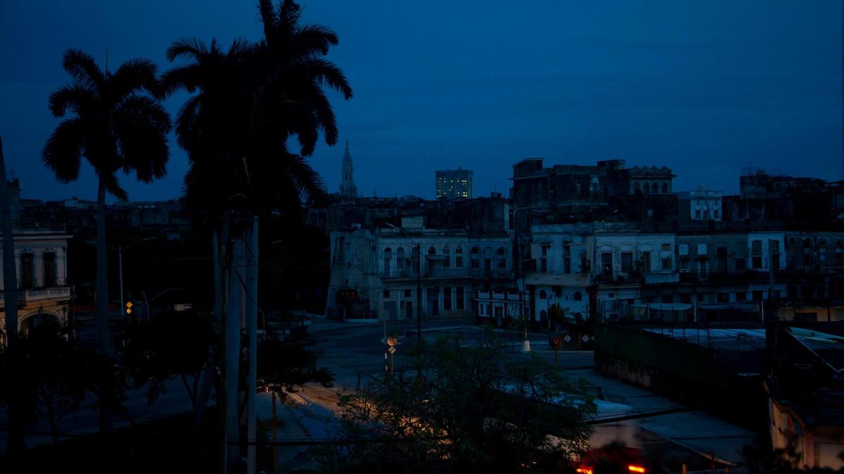 A neighborhood sits dark during a blackout triggered by the passing of Hurricane Ian in Havana, Cuba, early morning Wednesday, Sept. 28, 2022. Hurricane Ian knocked out electricity to the entire island when it hit the island’s western tip as a major storm. (AP Photo/Ismael Francisco)