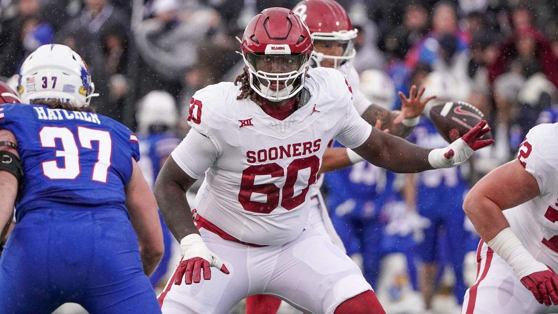 Oklahoma Sooners offensive lineman Tyler Guyton (60) at the line of scrimmage against the Kansas Jayhawks during the game at David Booth Kansas Memorial Stadium.