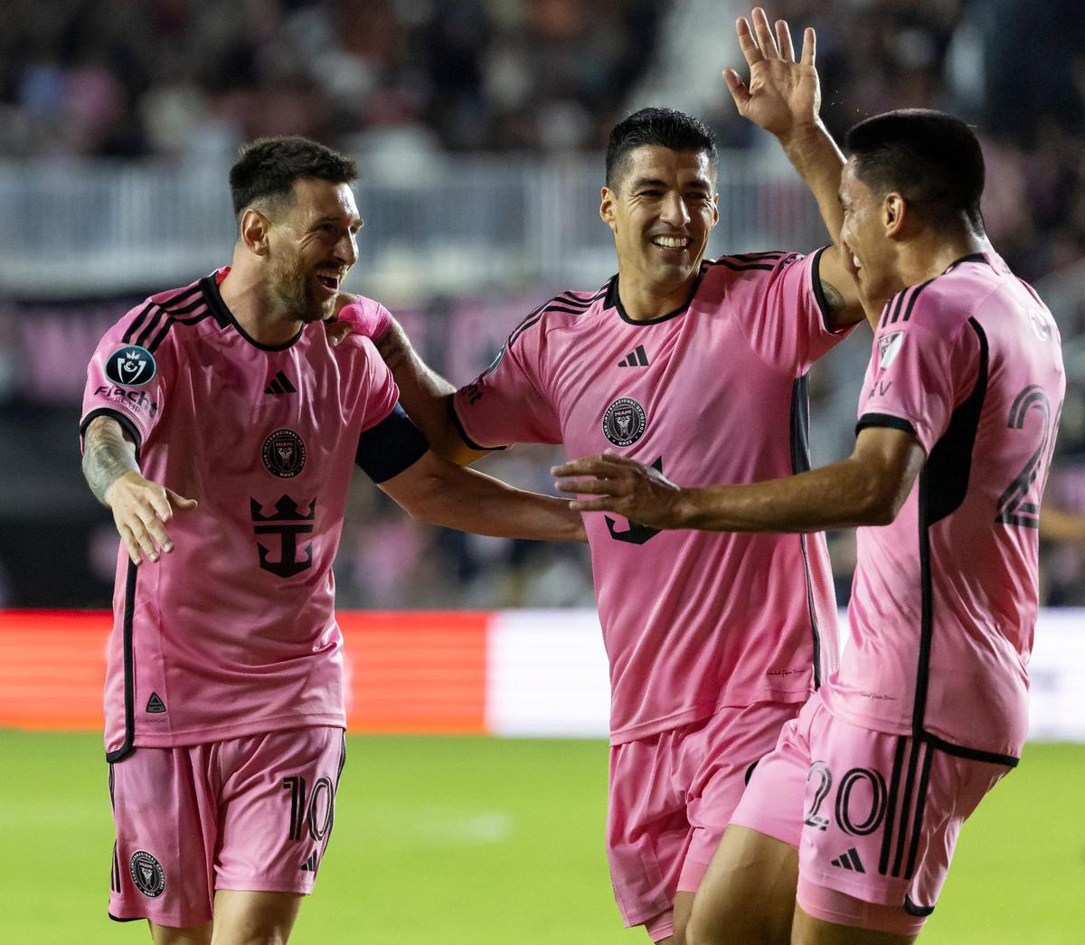 Inter Miami forward Lionel Messi (10) celebrates with Luis Suárez (9) and Diego Gómez (20) after scoring a goal against Nashville SC in the first half of their CONCACAF Champions Cup tournament soccer match at Chase Stadium on Wednesday, March 13, 2024, in Fort Lauderdale, Fla.