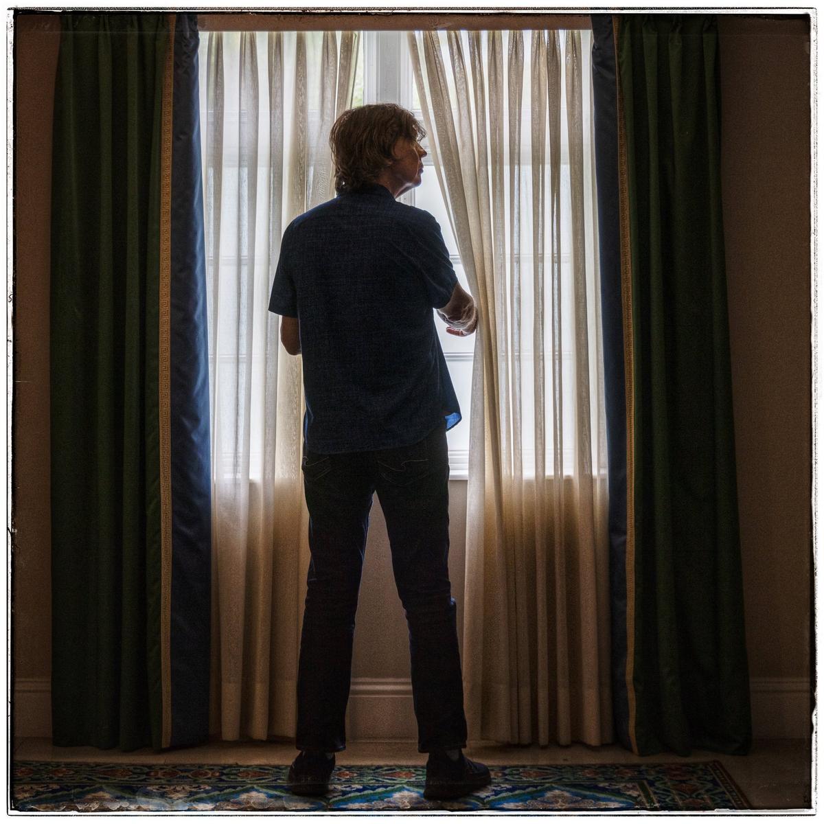 Thurston Moore, co-founder of the innovative and influential indie-rock band Sonic Youth, peeks through a hallway window curtain at the Biltmore Hotel in Coral Gables. Moore, a Coral Gables native, now spends winters in the city of his birth. His mother served as a volunteer at the hotel when it was a military hospital during World War II.