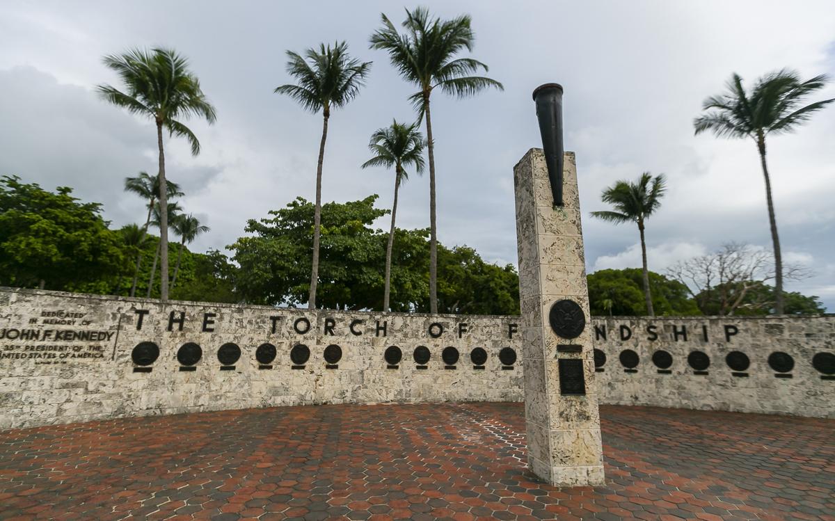 Behind the Torch of Friendship, the 40-foot-long curved keystone wall embedded with the bronze seals of 20 countries is in good shape, but the spot intended for a Cuba plaque is empty.