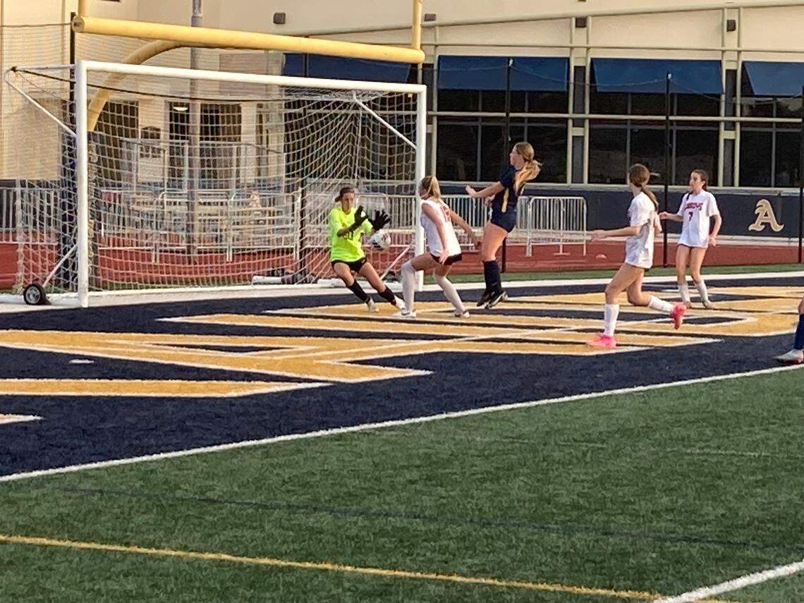 Cooper City goalkeeper Alyssa Morgan (left) frustrated St. Thomas Aquinas players all game long as she recorded one of her 20 saves during the Region 4-6A semifinal at Aquinas on Friday night.