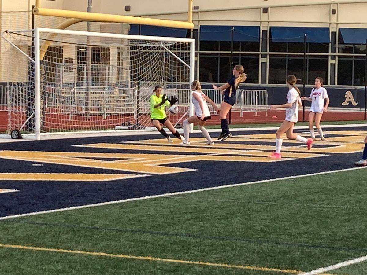 Cooper City goalkeeper Alyssa Morgan (left) frustrated St. Thomas Aquinas players all game long as she recorded one of her 20 saves during the Region 4-6A semifinal at Aquinas on Friday night.