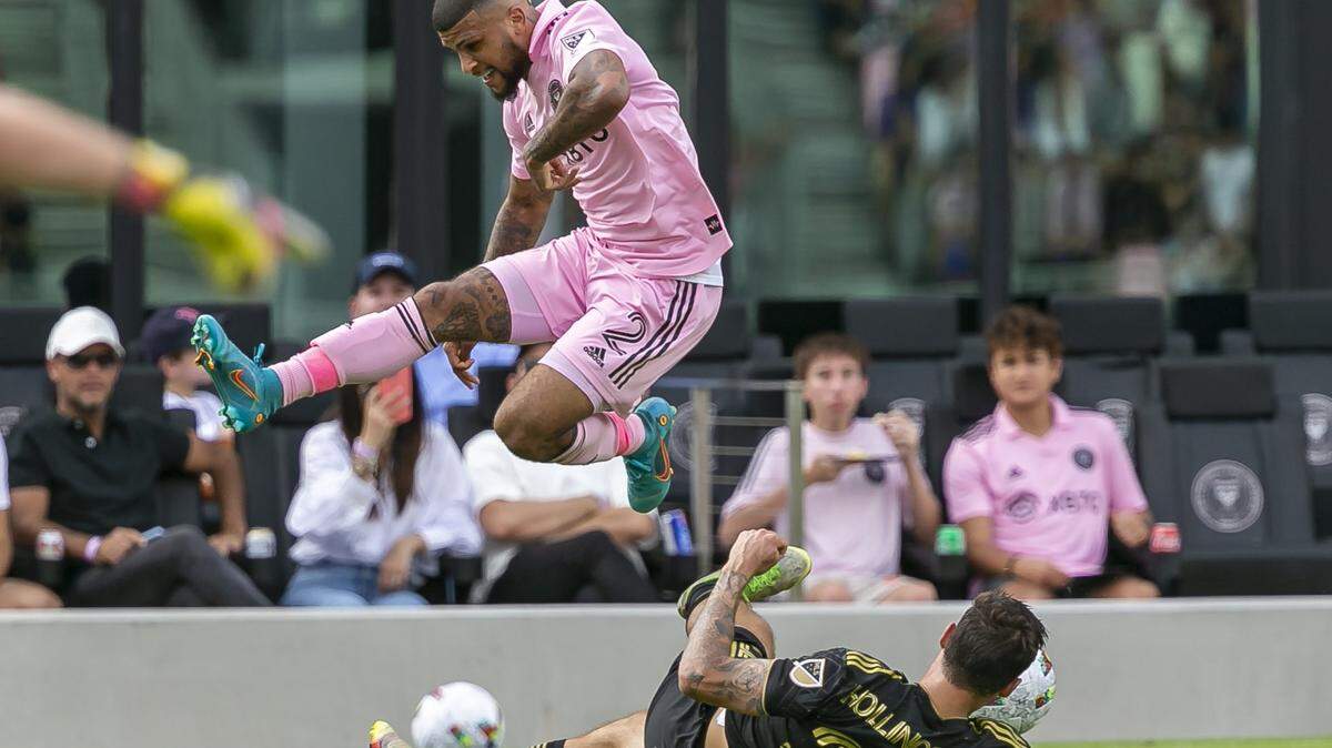 Inter Miami defender DeAndre Yedlin (2) jumps over Los Angeles FC midfielder Ryan Hollingshead (24) during the first half of their MLS soccer match at DRV PNK Stadium on Saturday, March 12, 2022, in Fort Lauderdale, Florida.