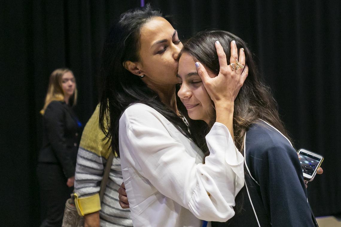 Alana Kaplan kisses her daughter, Simone Kaplan, of St. Bonaventure Catholic School, after she won the 79th Annual Miami Herald Broward Spelling Bee at Charles F. Dodge City Center in Pembroke Pines on Wednesday, March 6, 2019. Simone spelled the championship word naveta to win the competition.