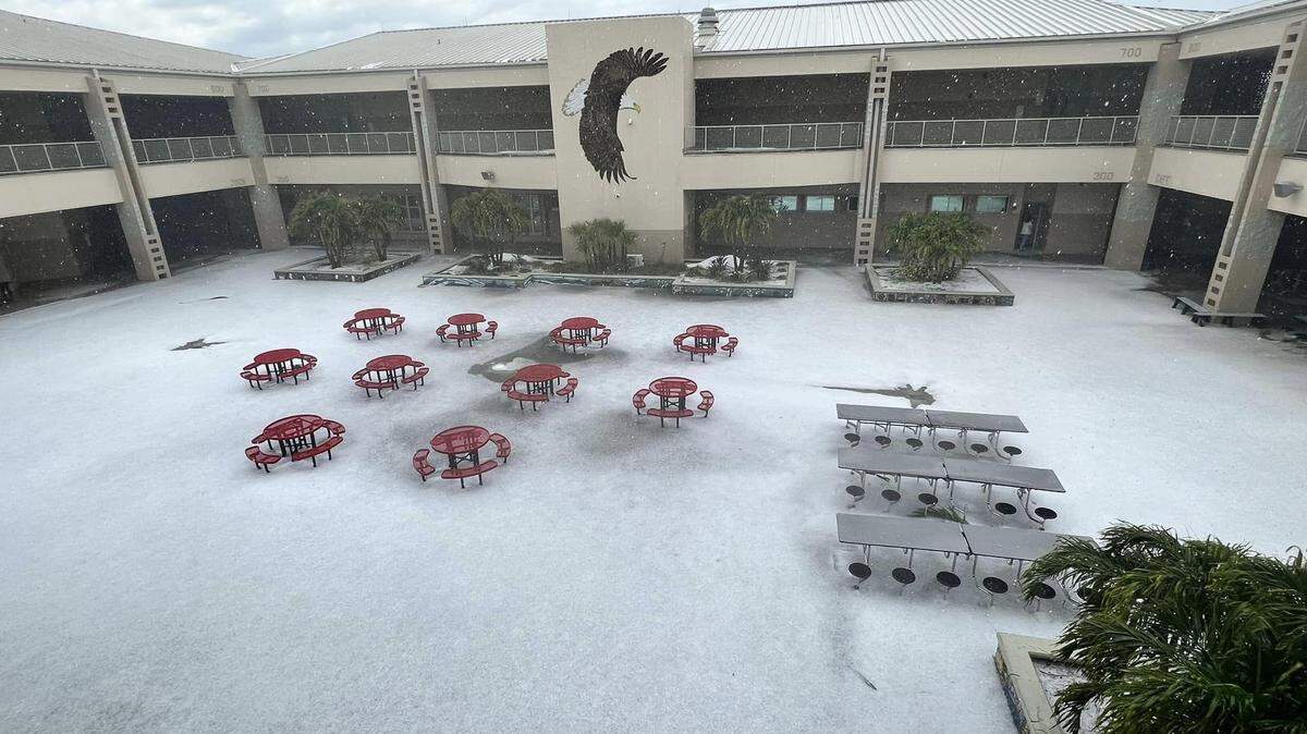Hail covers the ground of Central Middle School’s indoor patio in Brevard County on April 26, 2023.