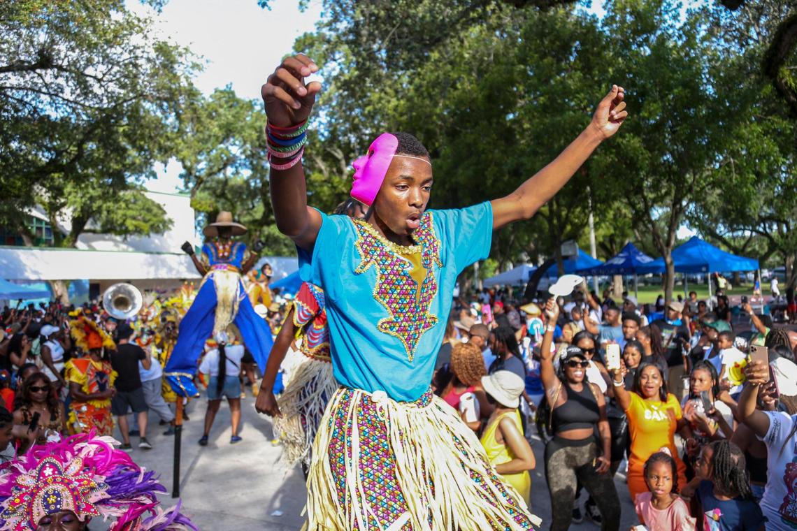 A Mocko Jumbie stilt walker dances to the music of the Junkanoo band during a parade at the Coconut Grove Bahamian Goombay Festival at Elizabeth Virrick Park in Coconut Grove on Sunday, June 12, 2022.