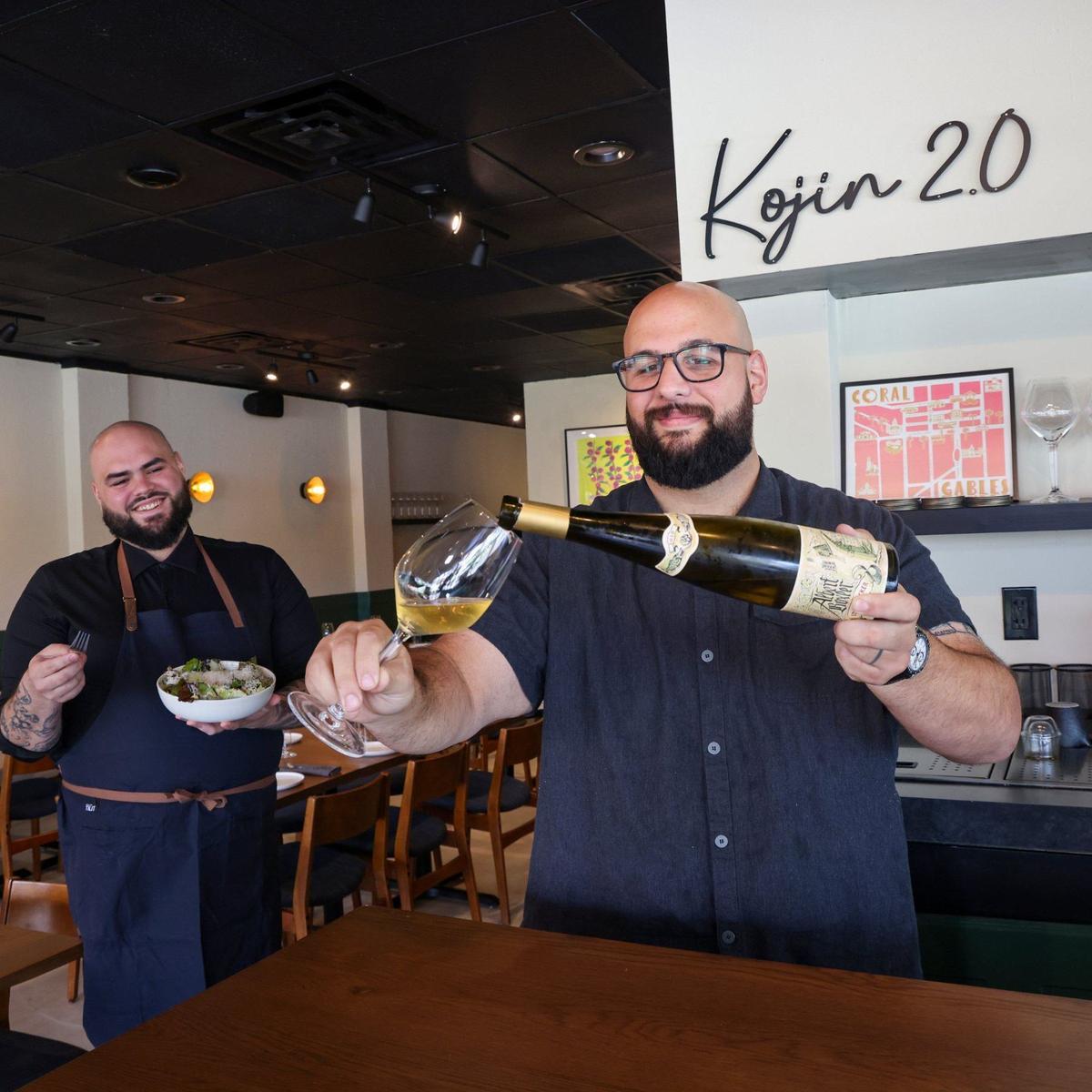 Sous chef Christopher Suarez watches executive chef Pedro Mederos pour a glass of Austrian Riesling at Kojin 2.0 in Coral Gables.