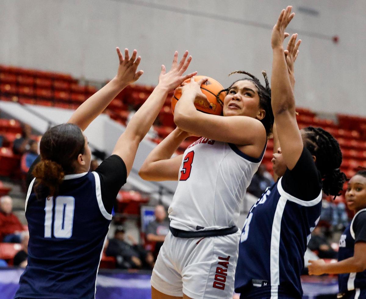 Doral Academy’s Victoria Valle (3) keeps an eye on the basket as Dr. Phillips’ Ciara Hayes (10) and Kiarra Orphelia (23) defend in the first half of the Class 7A semi-final for Girls High School Basketball State Championship at the RP Funding Center in Lakeland, Florida on Friday, March 7, 2025.