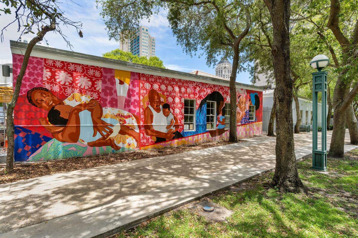 Mark Fleuridor’s “Being Held” mural covers one wall at the Carol Glassman Donaldson Childcare Center, across from the Miami-Dade Children’s Courthouse. 