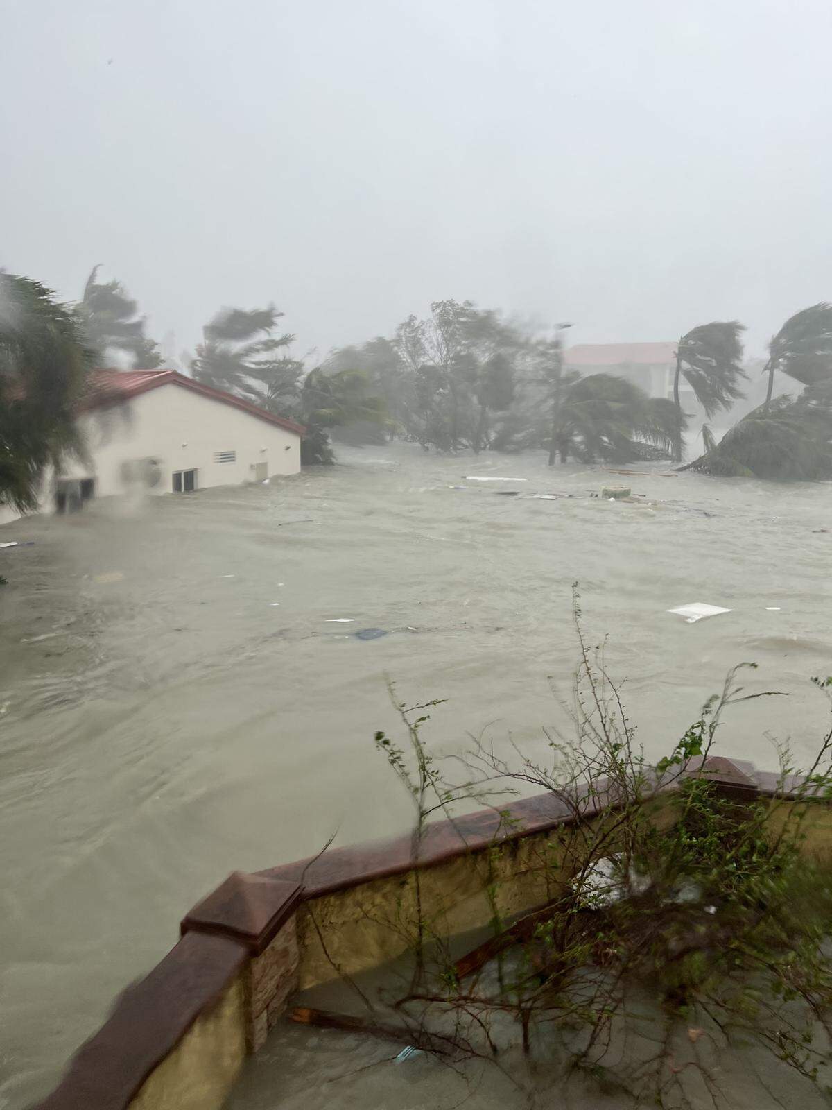 Storm surge from Hurricane Ian is seen rising inside and outside the walls of the Monastery of San Damiano of the Poor Clares on Fort Myers Beach on Sept. 28, 2022. This view is from a second story window of the monastery and the Ascension Parish Hall can be seen in the background. The water eventual topped the wall, inundating the ground floor, as well as the chapel, offices, hall, rectory and Parish church.